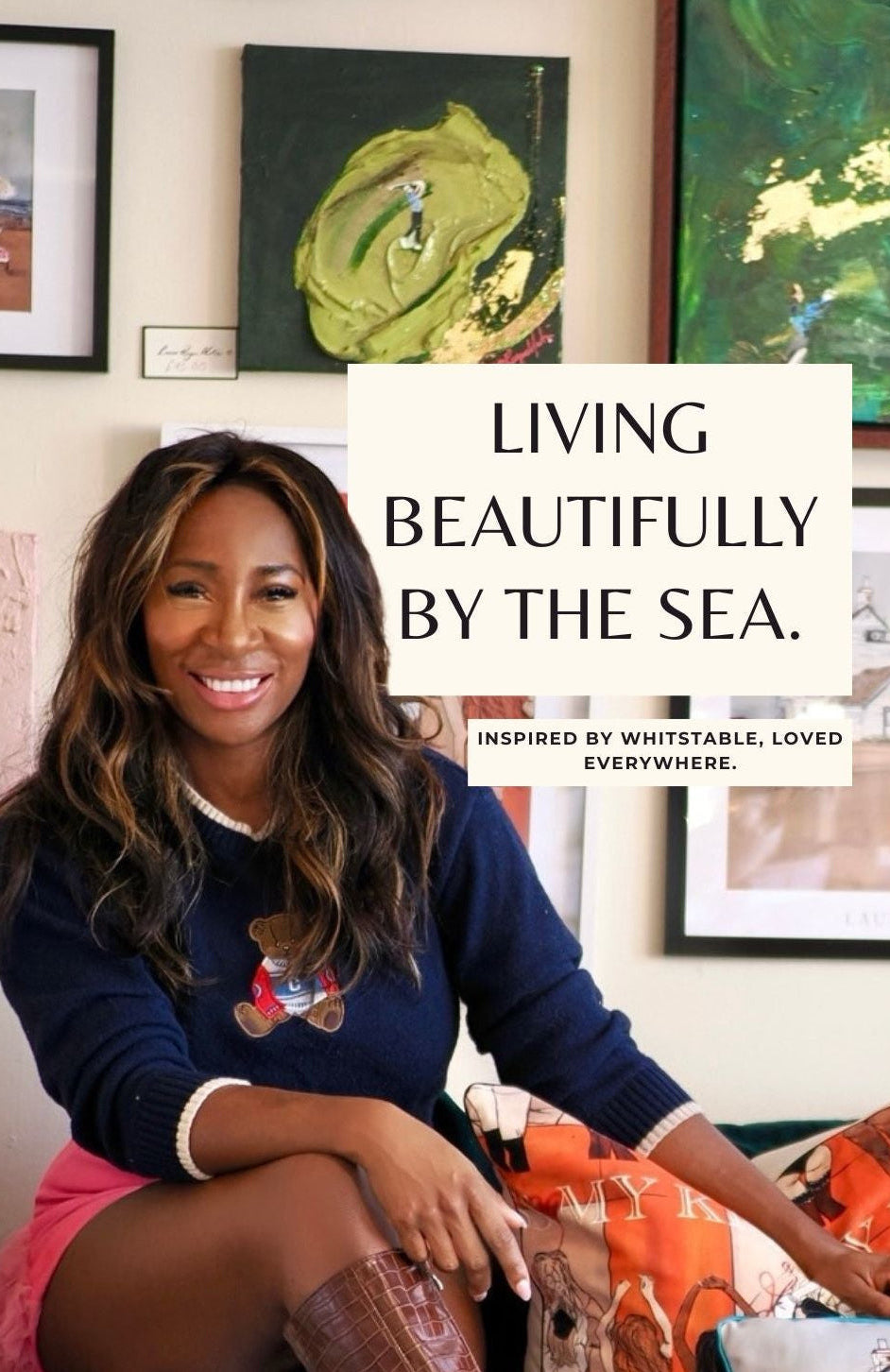 Woman sitting on a couch with art on the wall, text overlay 'Living Beautifully by the Sea'.
