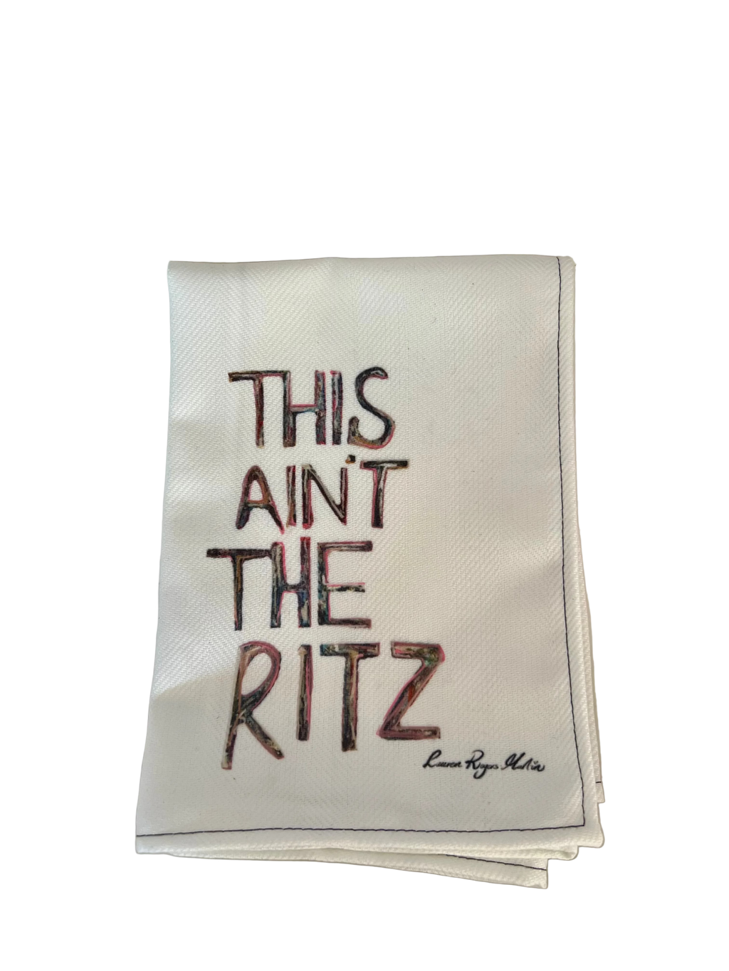 Napkin with 'This ain't the Ritz' text on a table setting